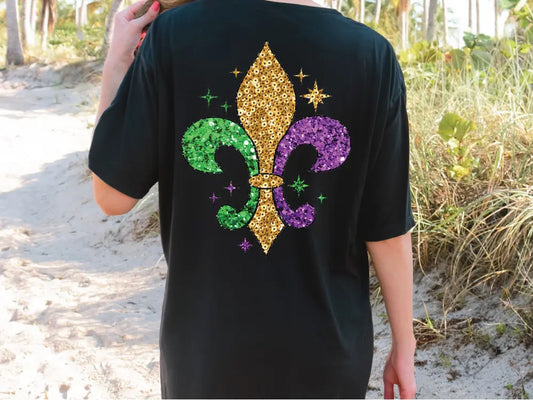 a person wearing a black shirt with a fleur de lis on it