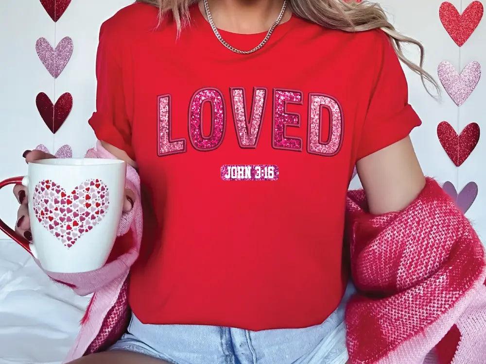 a woman in a red shirt holding a coffee cup