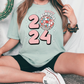 a woman sitting in front of a cactus wearing a t - shirt with the number