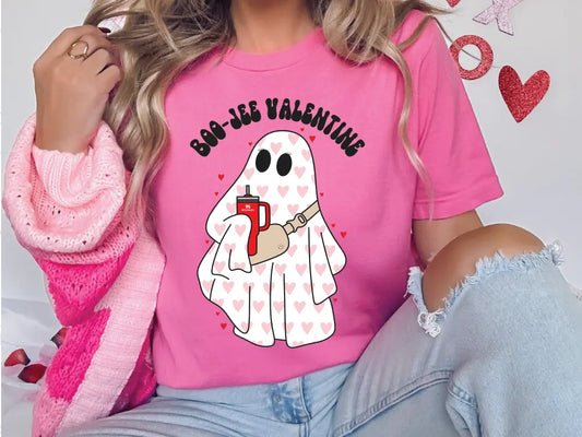 a woman wearing a pink shirt with a ghost on it