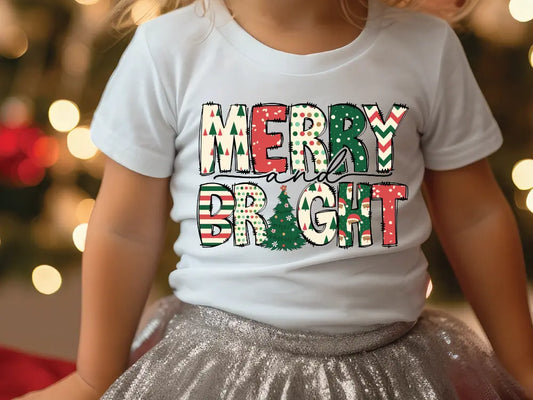 a little girl wearing a merry bright t - shirt