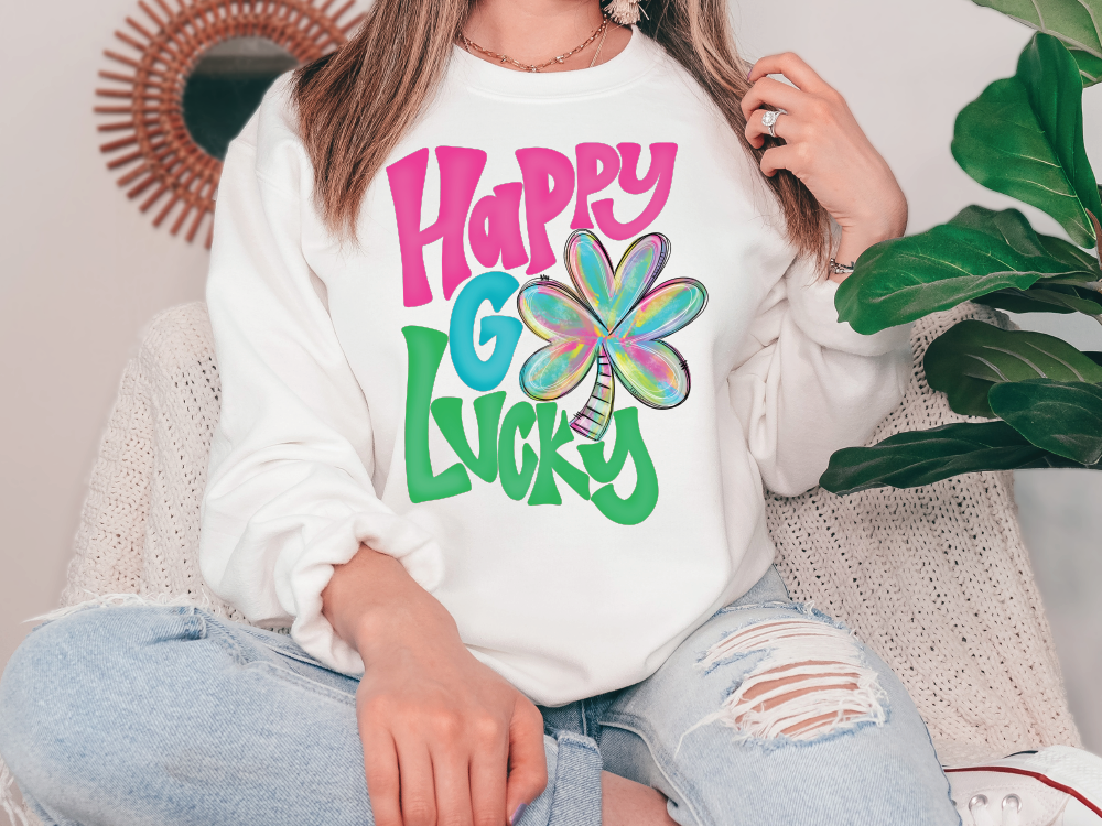 a woman sitting on a couch wearing a happy go lucky sweatshirt