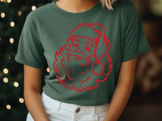 a woman wearing a green shirt with a red santa clause on it