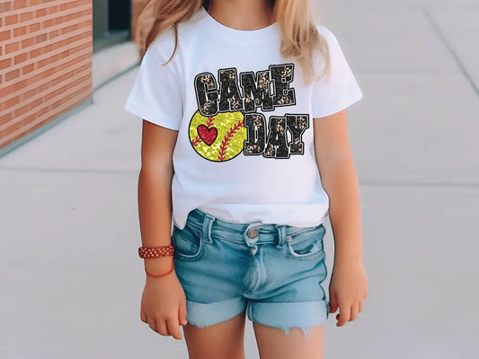 a little girl wearing a t - shirt that says game day