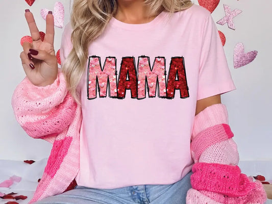 a woman wearing a pink shirt with the word mama written on it