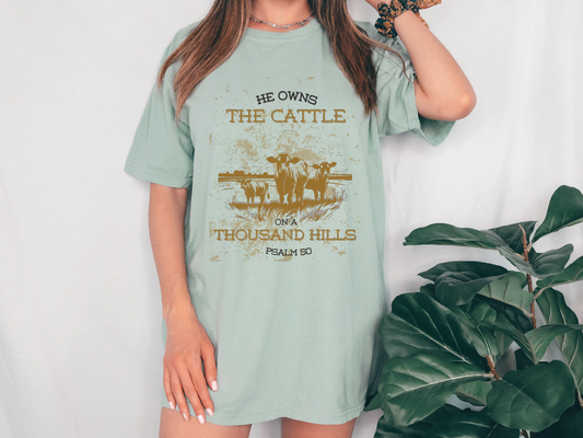 a woman wearing a t - shirt that says he owns the cattle