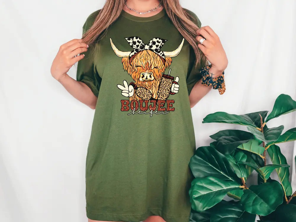 a woman wearing a green shirt dress with a cow on it