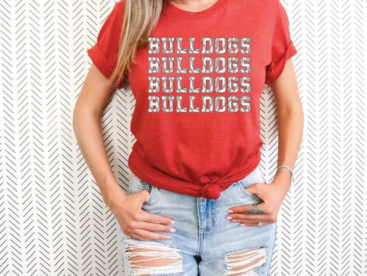 a woman wearing a red shirt with the words bulldogs on it