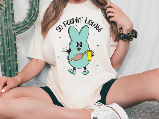 a woman wearing a t - shirt with a cartoon character on it