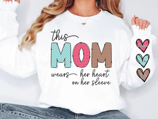a woman wearing a sweatshirt that says, this mom wears her heart on her sleeve