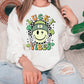 a woman sitting on a couch wearing a lucky vibes sweatshirt