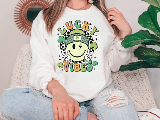a woman sitting on a couch wearing a lucky vibes sweatshirt