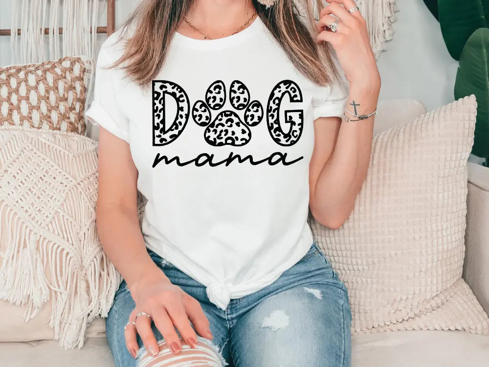 a woman sitting on a couch wearing a dog mama shirt