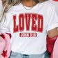 a woman wearing a t - shirt with the word loved printed on it