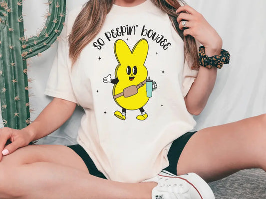 a woman sitting on the ground wearing a t - shirt with a pikachu