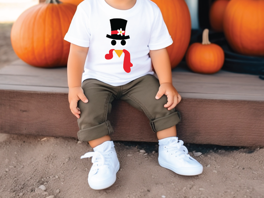 a little boy sitting on a step with pumpkins in the background