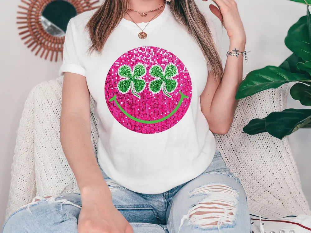 a woman sitting on a couch wearing a t - shirt with a smiley face on