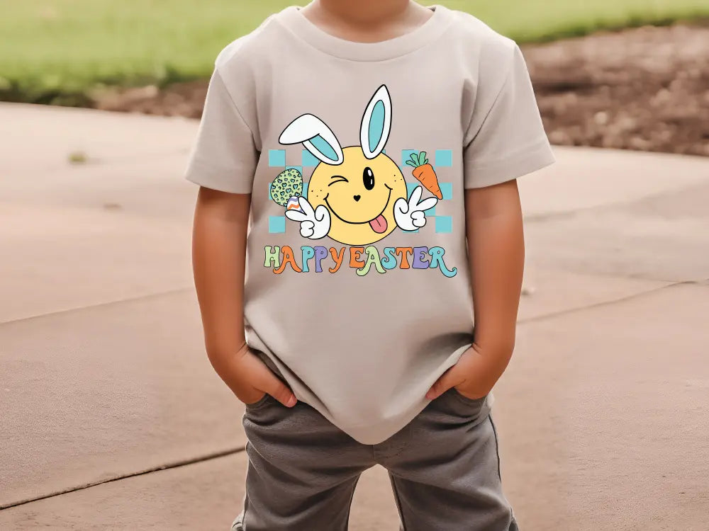 a young boy wearing a happy easter t - shirt