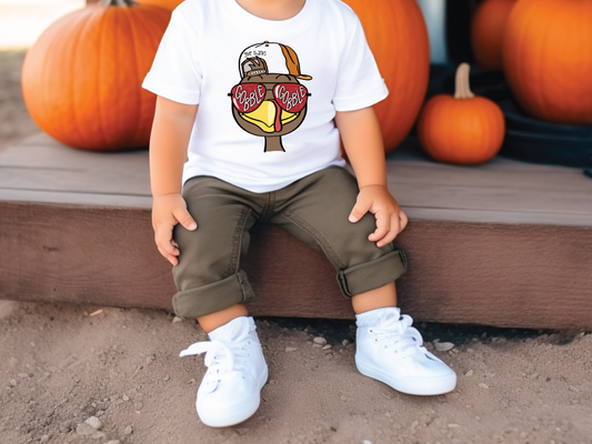 a little boy sitting on a step next to pumpkins