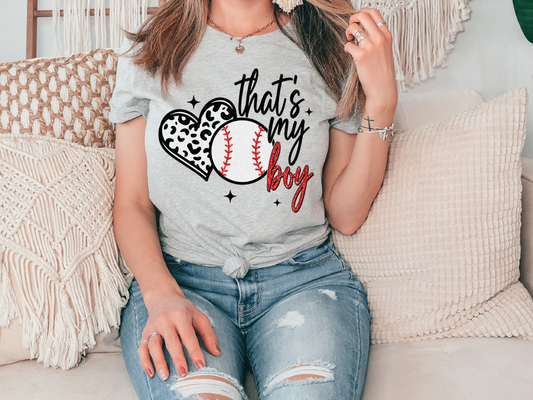 a woman sitting on a couch holding a baseball