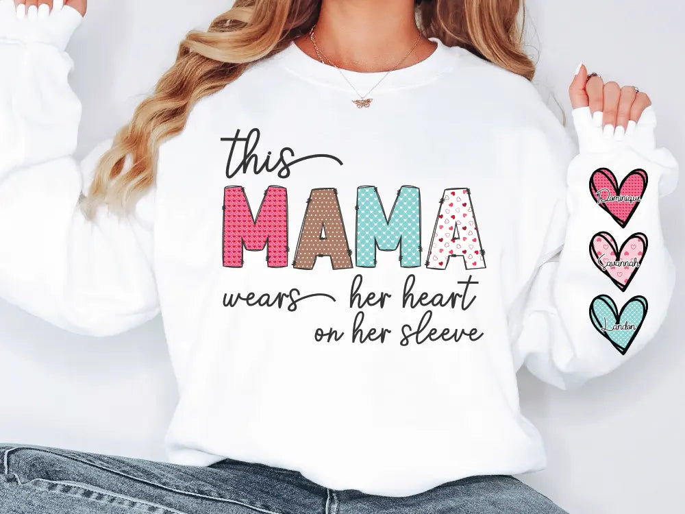 a woman wearing a white shirt that says, this mama wears her heart on her