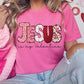 a woman wearing a pink jesus is my valentine shirt