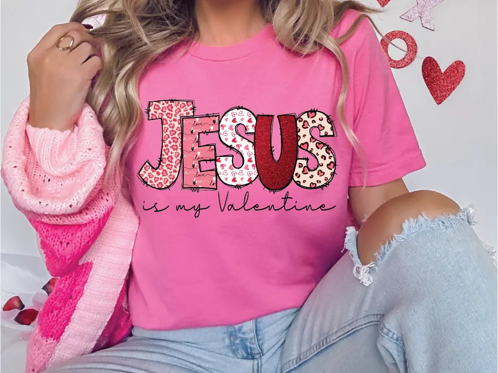 a woman wearing a pink jesus is my valentine shirt