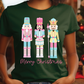 a woman wearing a green t - shirt with three nutcrackers on it
