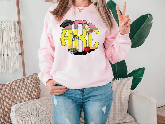 a woman wearing a pink sweatshirt with the word girl on it