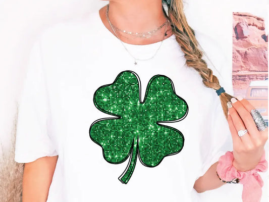 a woman wearing a t - shirt with a shamrock on it