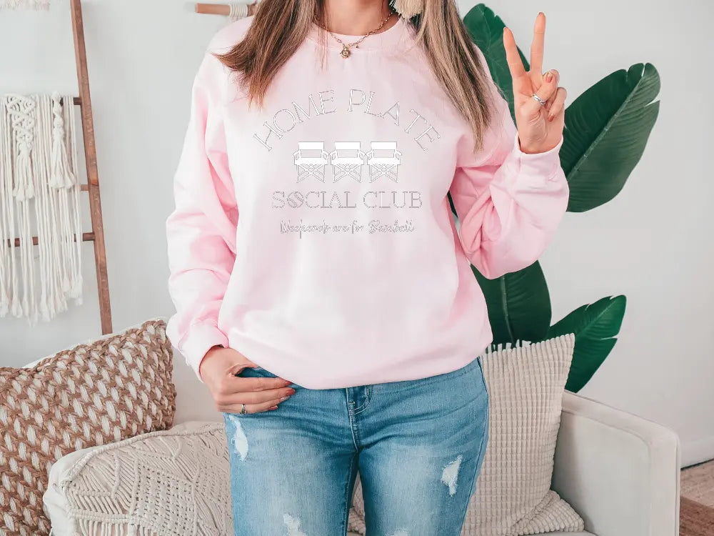 a woman wearing a pink sweatshirt and jeans