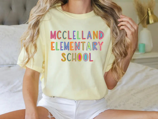 a woman sitting on a bed wearing a t - shirt that says mcclelland