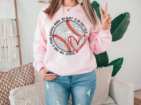 a woman wearing a pink baseball sweatshirt with a heart on it