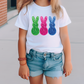 a little girl wearing a t - shirt with a pair of bunny ears on it