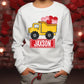 a young boy wearing a personalized sweatshirt with a dump truck
