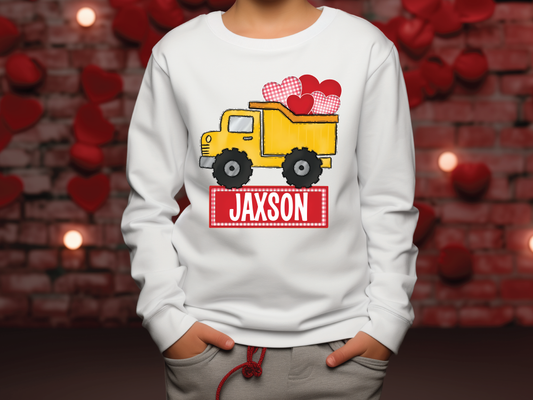 a young boy wearing a personalized sweatshirt with a dump truck