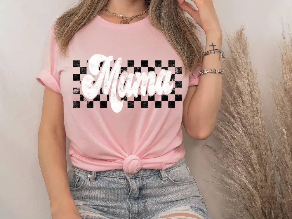 a woman wearing a pink shirt with a black and white checkered design