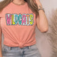 a woman wearing a pink shirt with the word wildcats on it