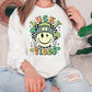 a woman sitting on a couch wearing a lucky vibes sweatshirt