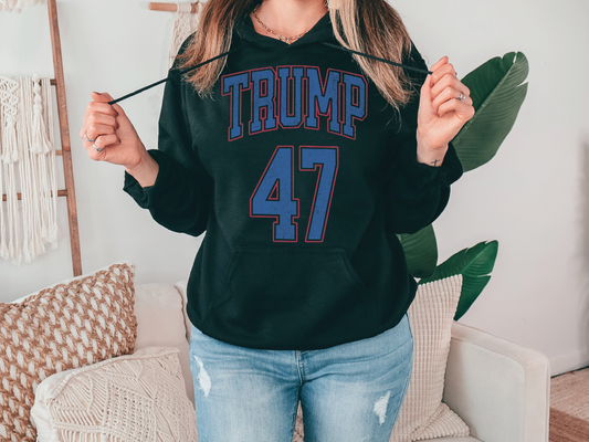 a woman wearing a black hoodie with the word trump 47 on it