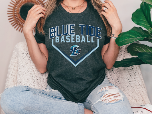 a woman sitting on a couch wearing a blue tide baseball t - shirt