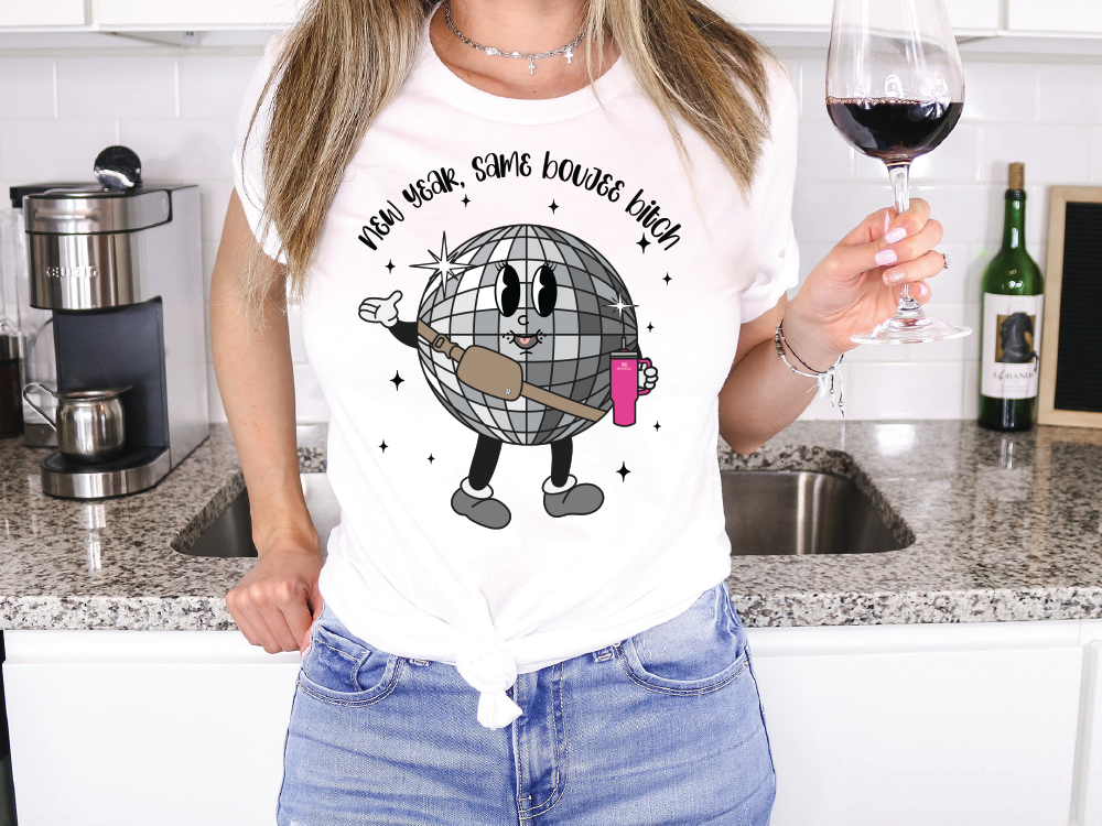 a woman holding a glass of wine in a kitchen
