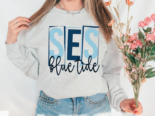 a woman wearing a sweatshirt that says ses blue tide