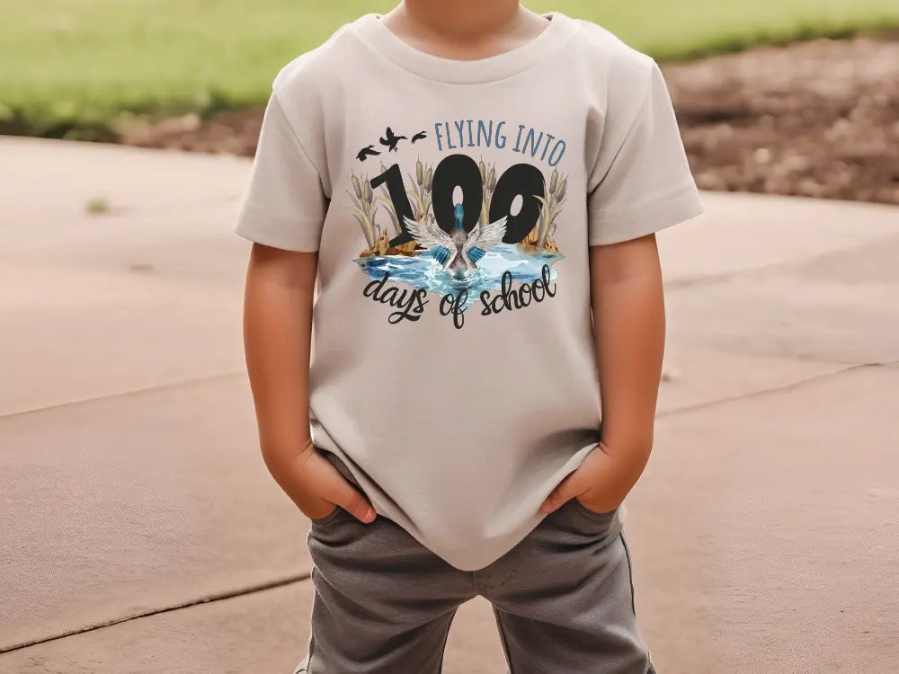 a young boy wearing a white shirt and gray pants