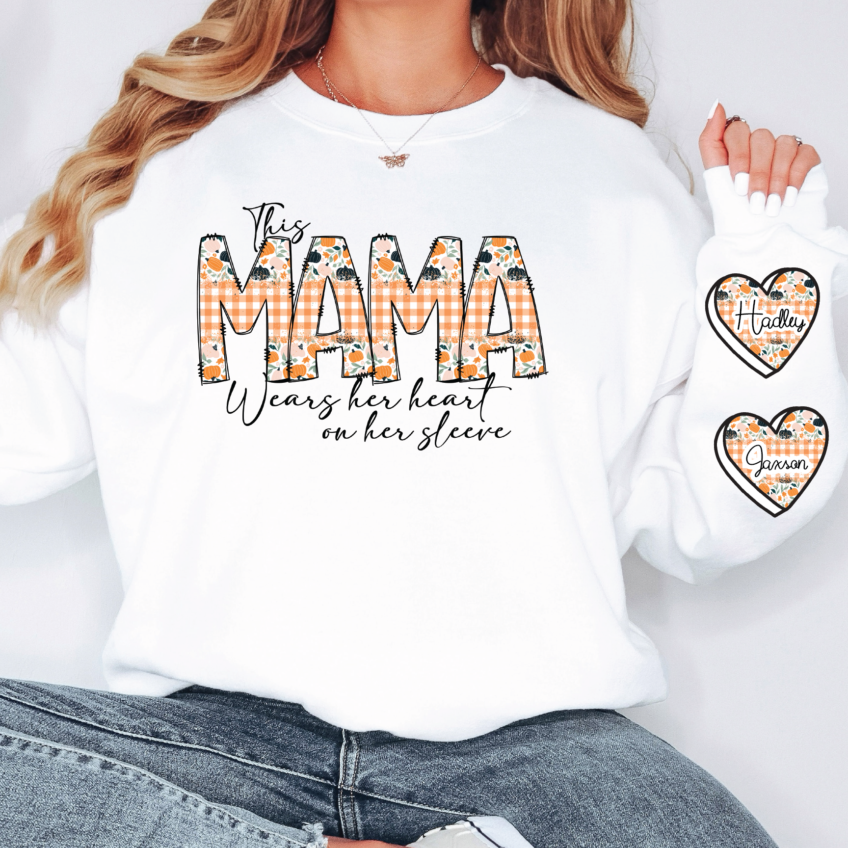 a woman wearing a white shirt with the word mama printed on it