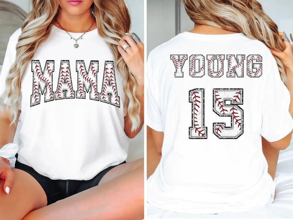 a woman sitting on a bed wearing a baseball shirt