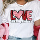 a woman wearing a t - shirt that says love is in the air