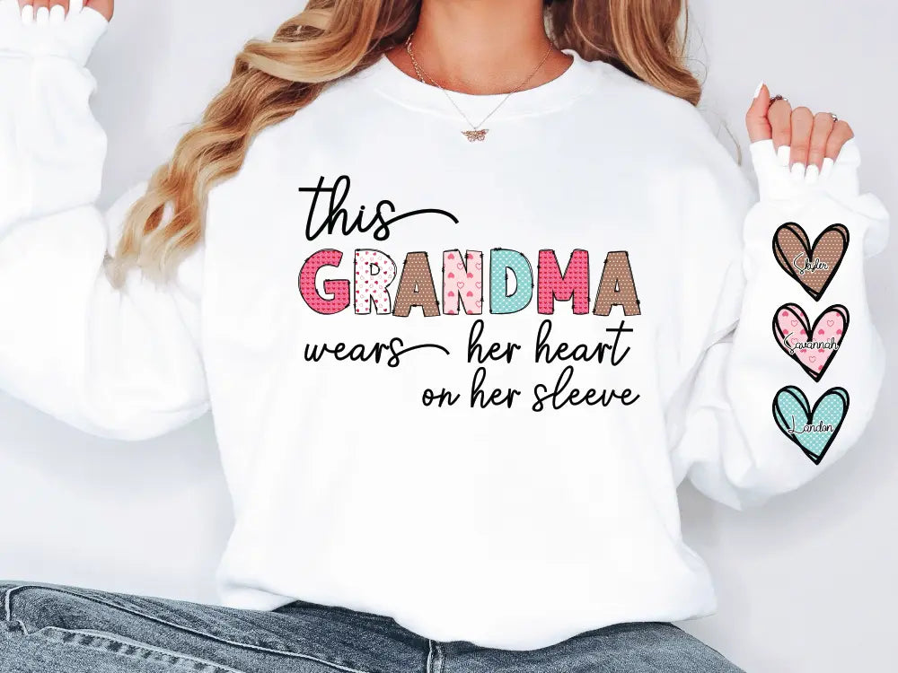 a woman wearing a white shirt that says, this grandma wears her heart on her