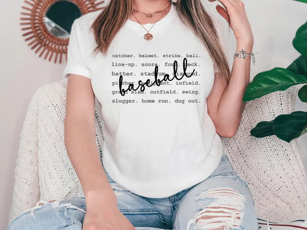 a woman sitting on a couch wearing a baseball t - shirt