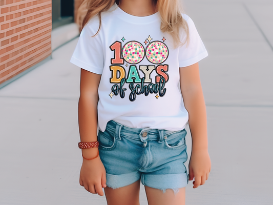 a little girl standing on a sidewalk wearing a t - shirt that says 100 days